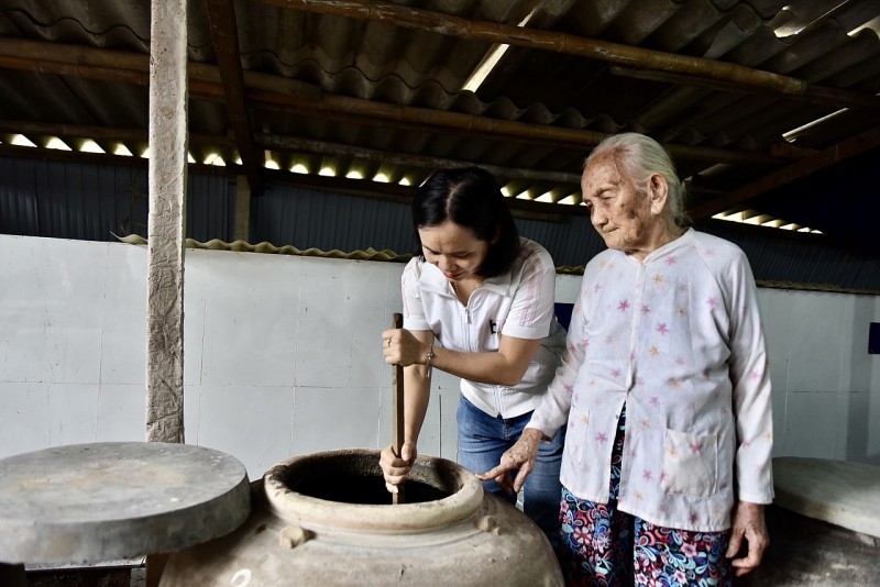 Ле Тхи Нгок Там, владелица фабрики по производству рыбного соуса «Нгок Лан», и её бабушка Чыонг Тхи Луан. Их семья поколение в поколении готовила рыбный соус известный в районе Тамтхань 